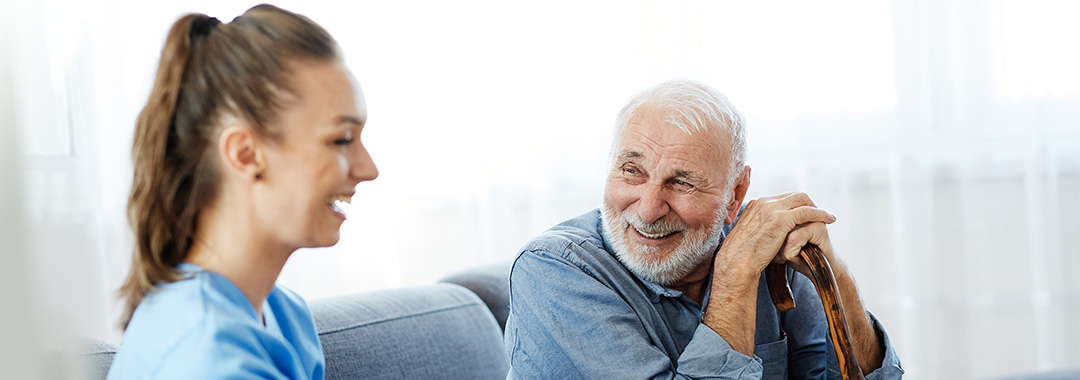 yolo-1080x380-5 A nurse laughing with an elderly man
